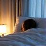 A person sleeping peacefully in a comfortable bed, illustrating optimized sleep